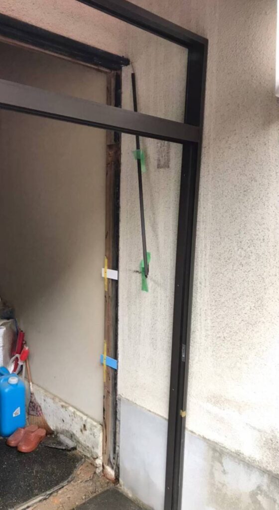 新しい玄関引戸の枠を取り付けている作業