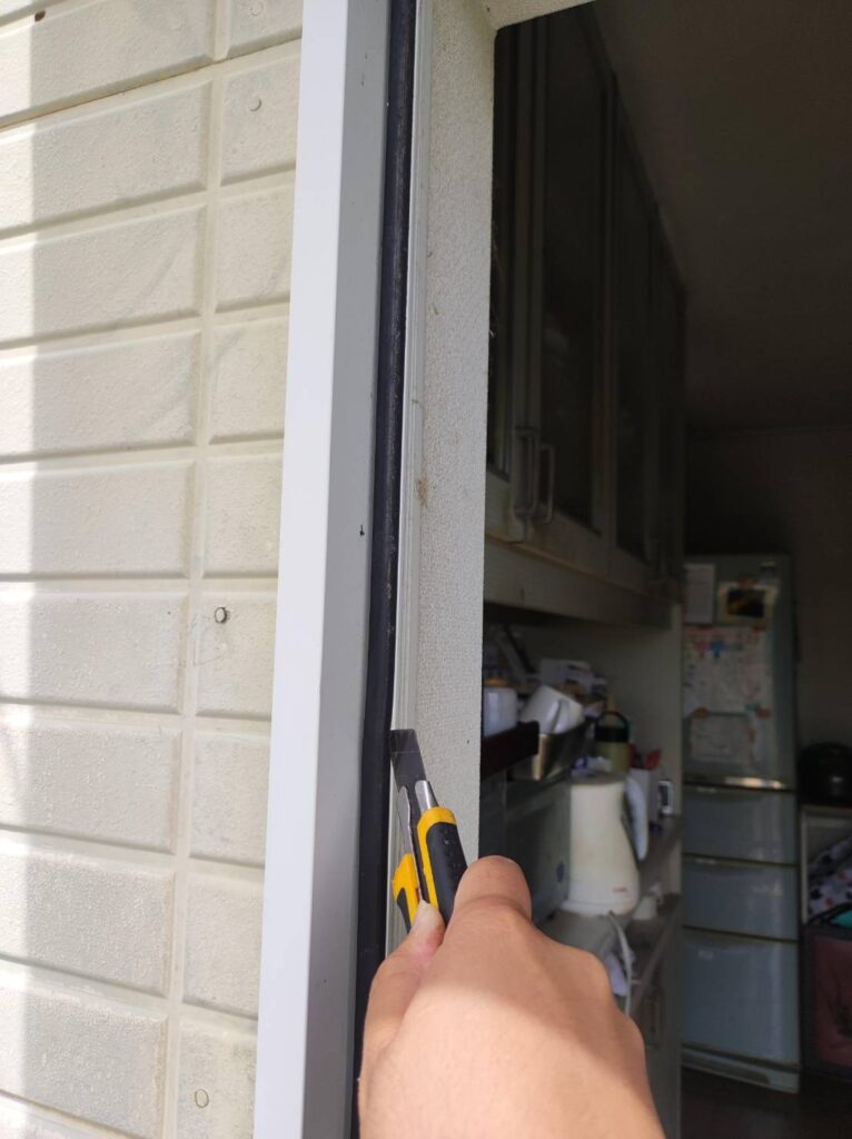 既存ドア枠への取付けに干渉する気密パッキンを取り除く作業